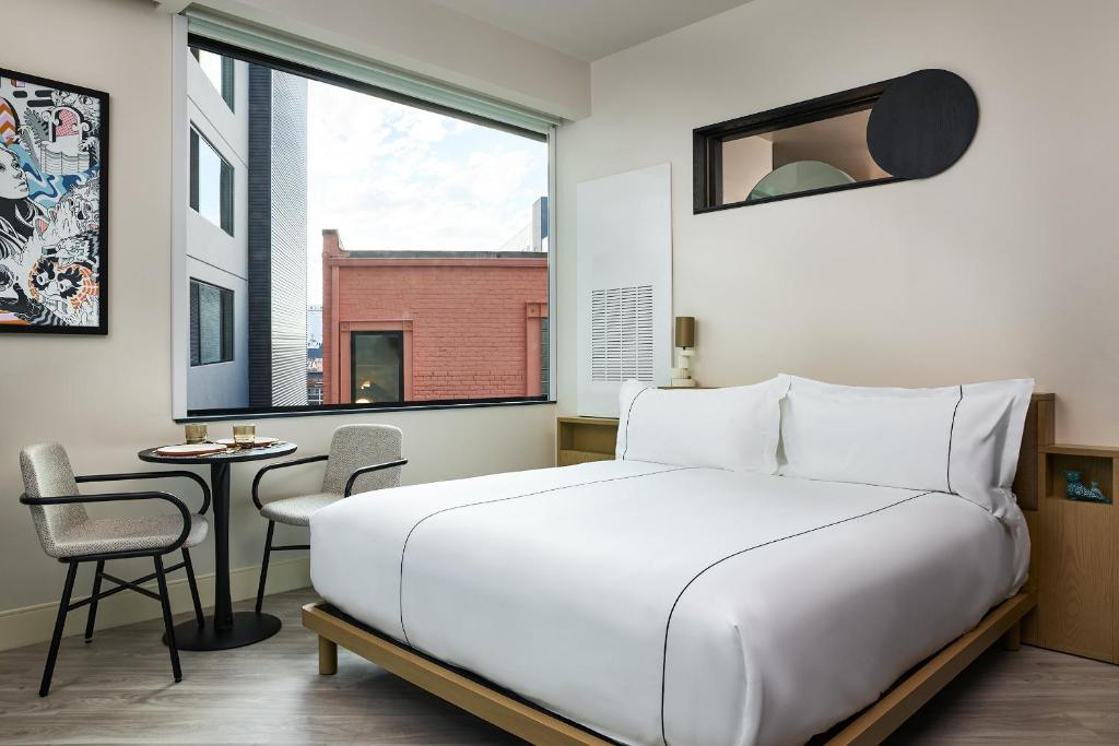 Catbird Hotel white bed next to the window