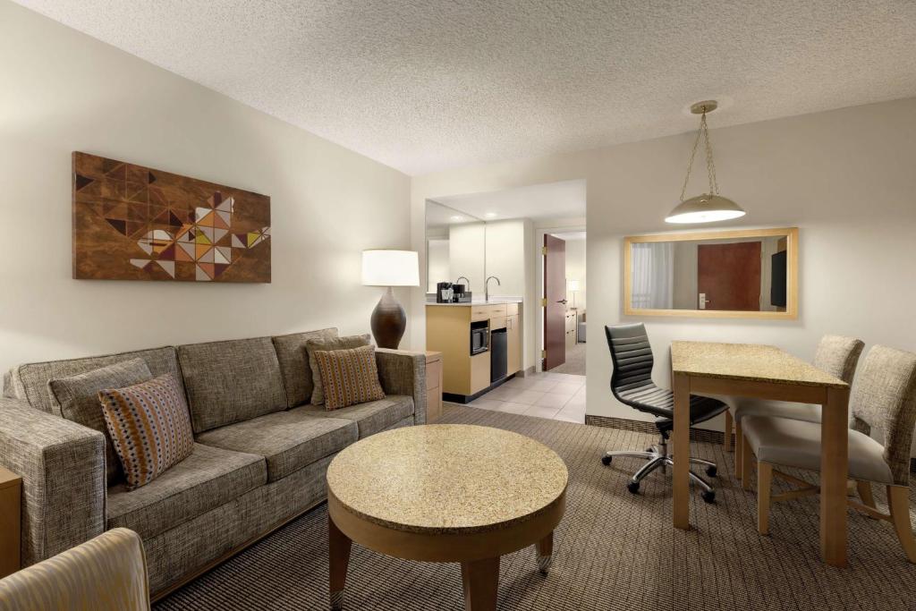 Embassy Suites by Hilton Denver International Airport hall with gray sofa